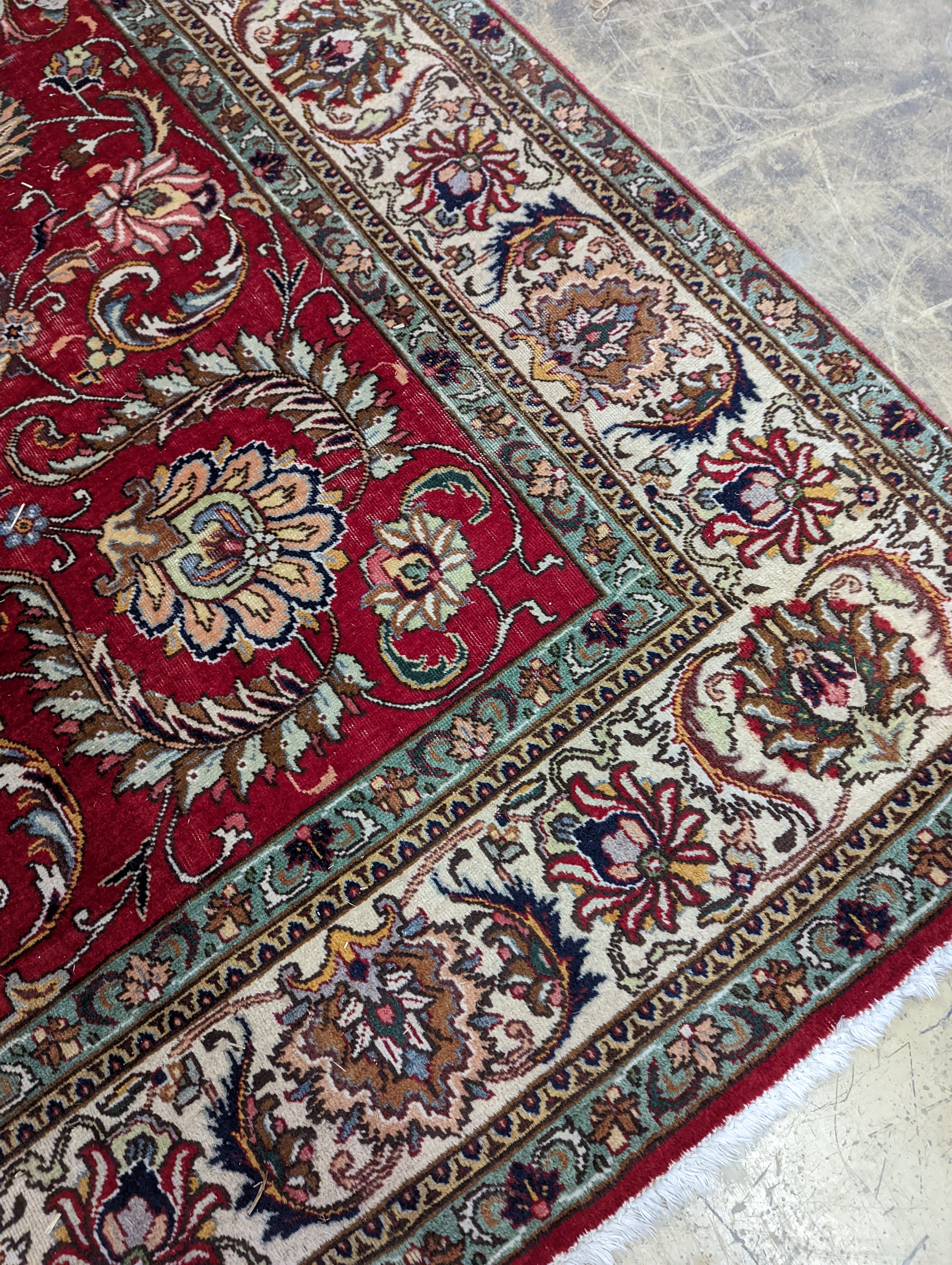 A Tabriz red ground carpet, 400 x 290cm